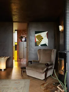 Contemporary living room featuring a stylish sofa, abstract art, and a cozy fireplace.