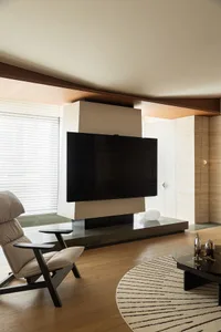 Modern living room featuring a minimalist design with wood and concrete elements.