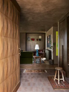A modern living room with wooden furniture and a textured ceiling.