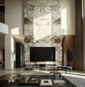 Modern living room with marble flooring, featuring a minimalist design with sleek, white furniture and metallic pendant light