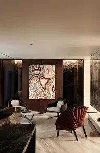 A modern living room featuring marble furniture and a colorful abstract painting.