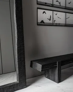 A modern metal bench with a black finish.