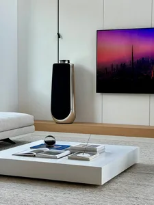 A modern minimalist living room featuring sleek, clean lines and a mix of white and wood materials.