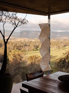 Modern residential space featuring large glass window with scenic landscape view.