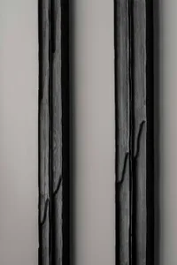 Vertical lines of dark wood panels against a neutral background