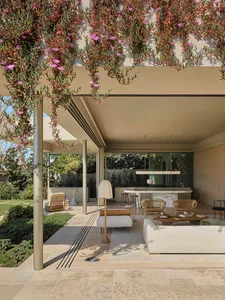 A minimalist patio with concrete, wood, and natural stone materials.