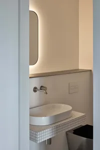 Modern bathroom featuring ceramic tiles and a minimalist design.