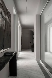Modern white marble interior with minimalist design and black accents.