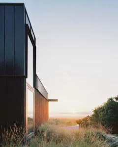 Modernist residential home with glass and wooden exterior.
