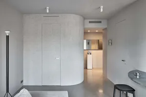 Interior design featuring minimalist space with concrete surfaces.