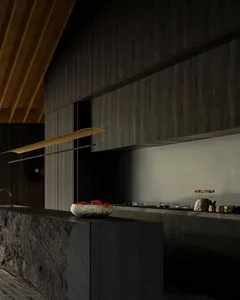 Modern kitchen with dark wooden cabinets and a stone countertop.