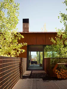Modern exterior architecture with metal siding and a metal chimney.