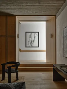 Modern minimalist interior design featuring natural wood elements and a cozy atmosphere.