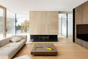 Industrial-style living room with wooden floors and furniture.
