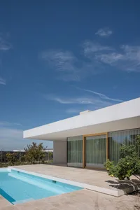 Modern residential exterior showcasing minimalist design with concrete materials.