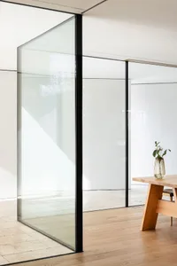 Modern interior with glass walls and wooden furniture