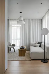 Modern living room with fabric furniture, wooden coffee table, glass pendants