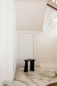 Contemporary minimalist interior featuring black wood furniture and marble flooring.