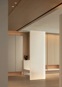 A minimalist residential interior featuring terrazzo and wood materials, showcasing sleek and modern design elements.