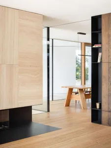 A minimalist residential space featuring wood and glass elements.