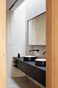 Modern bathroom featuring concrete walls and minimalist design elements.