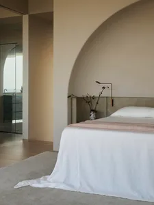 A modern bathroom with concrete tiles, featuring a walk-in shower and white accents.