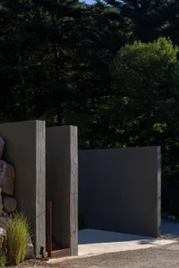 Modern architectural entrance featuring metal cladding and concrete materials.