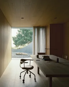A minimalist office space featuring a wood table, chair, and bookshelf with books and a lamp, set against a serene outdoor vi