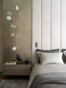 A minimalist bedroom with neutral tones and modern decor.