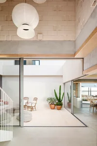 A minimalist living space featuring concrete flooring and a modern design.