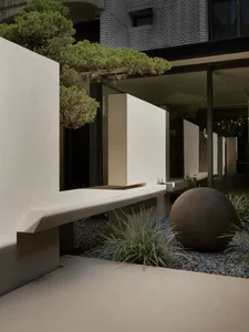Concrete modern architectural design featuring geometric shapes and greenery.
