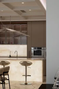 Modern kitchen featuring a minimalist design with a marble countertop and sleek, integrated appliances.