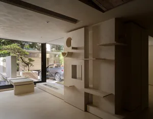 Modern living room interior with concrete elements, open space, and large windows.