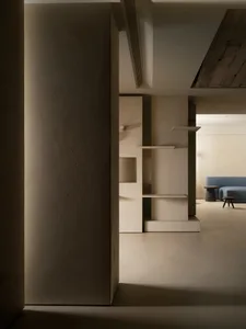 A modern minimalist interior featuring exposed cement walls and a sleek, linear design.
