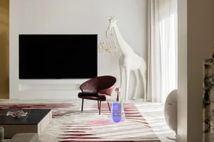Modern minimalist living room with white metal furniture and a white giraffe statue