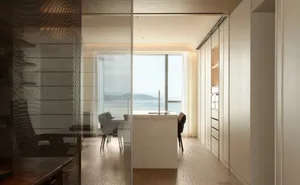 Modern residential kitchen featuring a terrazzo countertop and wooden flooring.