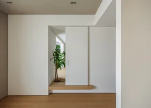 A minimalist interior space featuring wood and concrete materials.