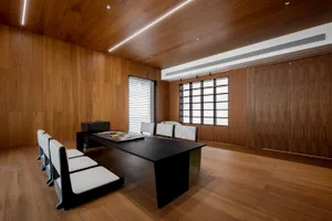 A minimalist office space featuring wooden surfaces and furniture.