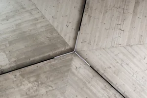Gray concrete ceiling panels with wood-like texture