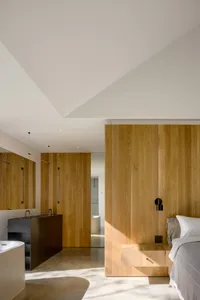 Modern bedroom featuring wood paneling and minimalist design