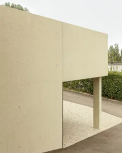A modern, minimalist building made of concrete with a flat roof.