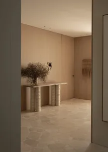 Modern entryway with natural stone flooring and minimalist design elements.