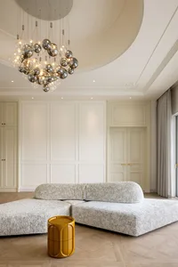 A modern living room with a fabric sofa and a yellow side table.