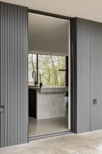 Modern minimalist kitchen with metal cabinets and concrete countertops