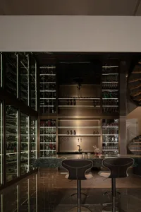 Minimalist design bar with glass shelves and bottles.