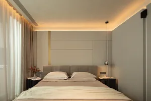 The minimalist bedroom features a bed with soft bedding on textured walls, creating a serene and inviting space.