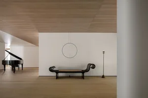 Minimalist style interior space featuring a combination of wood and metal materials and furniture.