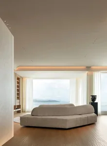 Modern residential interior with open-plan design and fabric furnishings.