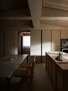 Modern kitchen with minimalist design, featuring a marble countertop and wooden furniture.