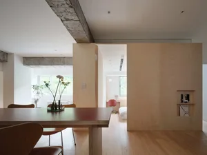 Modern residential interior with wooden furnishings and glass elements